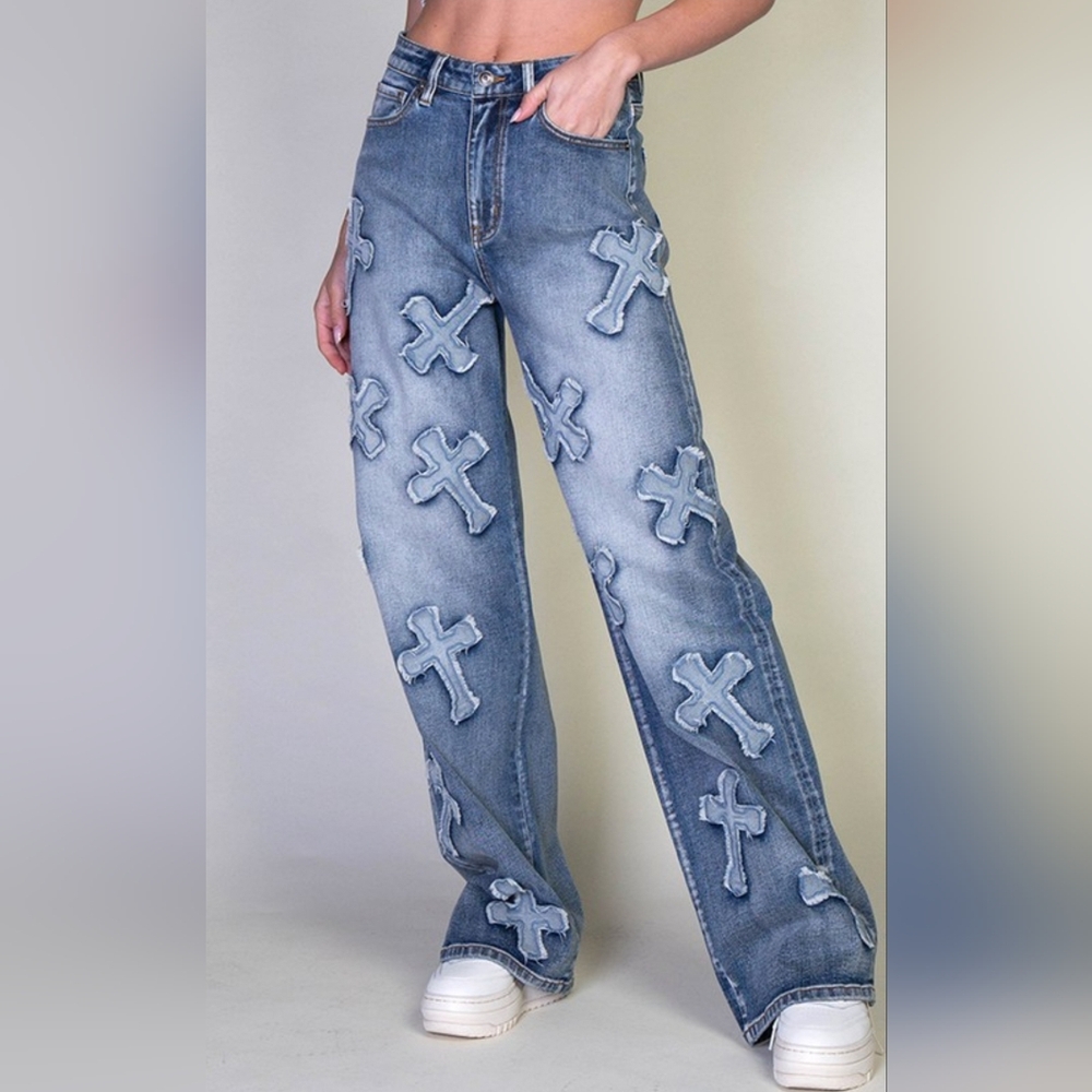 Mid rise straight legged jeans with cross patches.